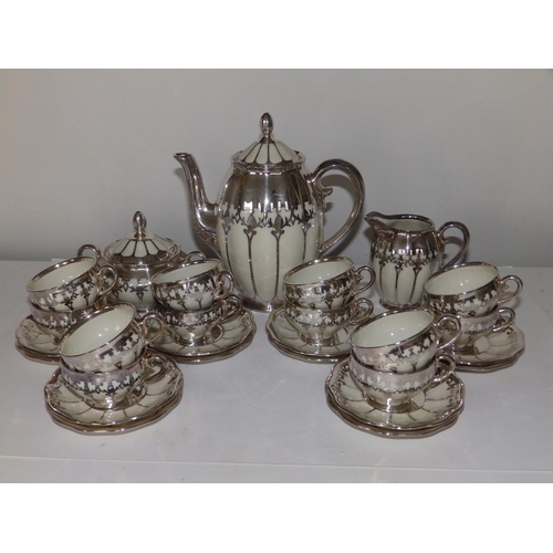 53 - A German Koenigszelt porcelain coffee set for 12 with silver mounts and onlaid decoration, comprisin... 