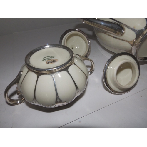 53 - A German Koenigszelt porcelain coffee set for 12 with silver mounts and onlaid decoration, comprisin... 