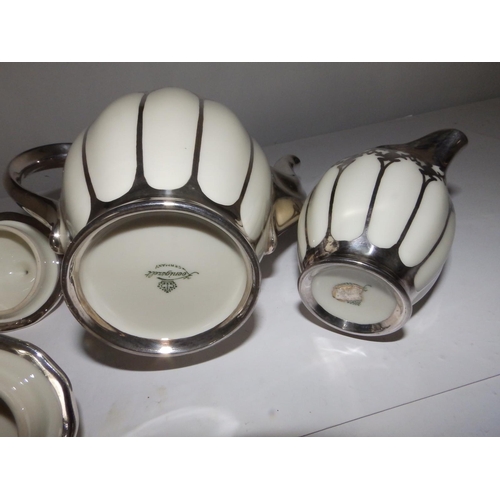 53 - A German Koenigszelt porcelain coffee set for 12 with silver mounts and onlaid decoration, comprisin... 