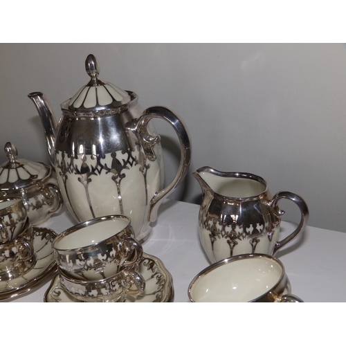 53 - A German Koenigszelt porcelain coffee set for 12 with silver mounts and onlaid decoration, comprisin... 