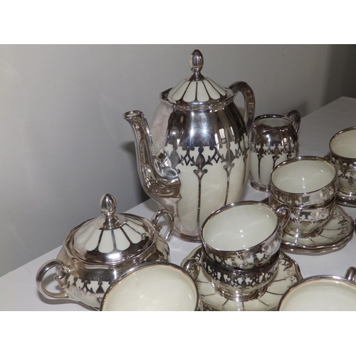 53 - A German Koenigszelt porcelain coffee set for 12 with silver mounts and onlaid decoration, comprisin... 