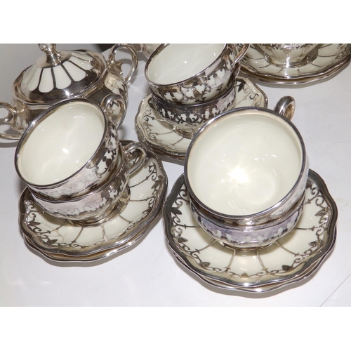 53 - A German Koenigszelt porcelain coffee set for 12 with silver mounts and onlaid decoration, comprisin... 