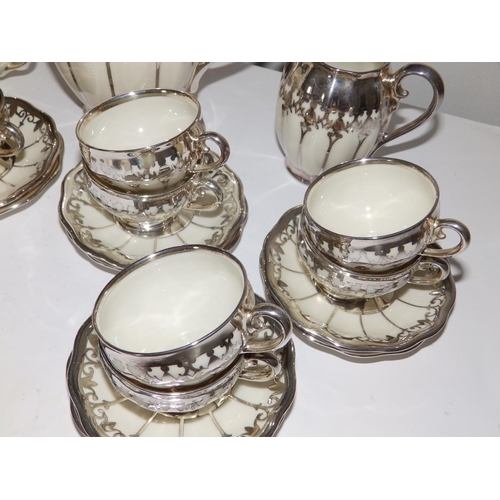 53 - A German Koenigszelt porcelain coffee set for 12 with silver mounts and onlaid decoration, comprisin... 