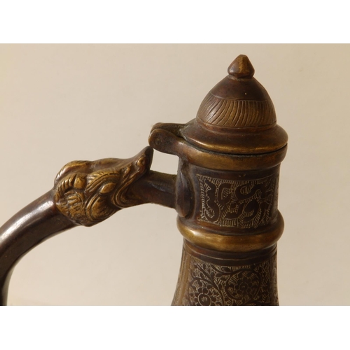 80 - A Persian bronze coffee pot with overall engraved decoration of scrolls and script, 11