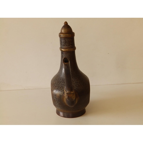 80 - A Persian bronze coffee pot with overall engraved decoration of scrolls and script, 11