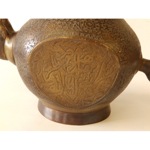 80 - A Persian bronze coffee pot with overall engraved decoration of scrolls and script, 11