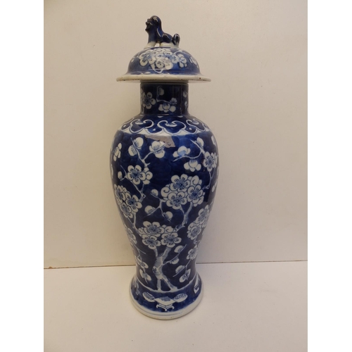 48 - A 19thC Chinese blue & white porcelain covered vase of slender meiping shape, painted with a prunus ... 