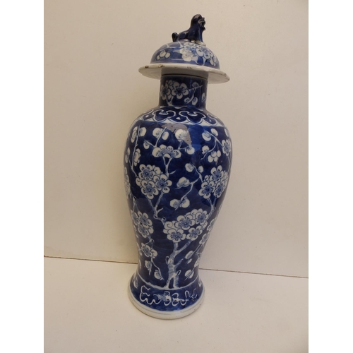 48 - A 19thC Chinese blue & white porcelain covered vase of slender meiping shape, painted with a prunus ... 