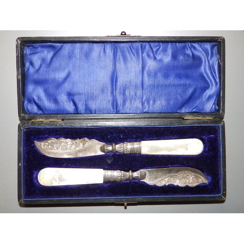 142 - A cased pair of mother-of-pearl handled silver butter knives. (2)