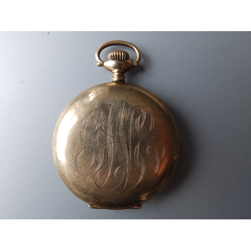 149 - A gold plated Waltham open faced pocket watch with subsidiary seconds in a folding carved wooden sta... 