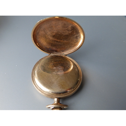 149 - A gold plated Waltham open faced pocket watch with subsidiary seconds in a folding carved wooden sta... 