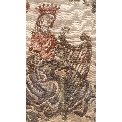 21a - An antique Irish embroidery, depicting a crowned female figure playing a harp, a crowned harp and sh... 