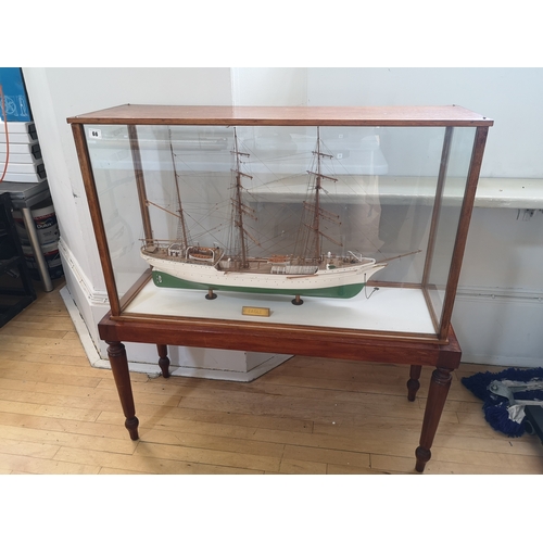 60a - A painted wooden model in glazed display case of the USCGC Barque Eagle, on mahogany stand with roun... 