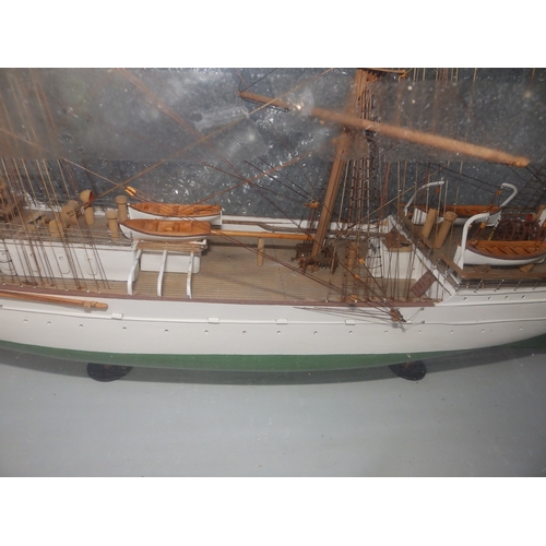 60a - A painted wooden model in glazed display case of the USCGC Barque Eagle, on mahogany stand with roun... 