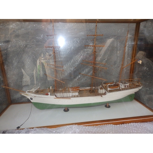 60a - A painted wooden model in glazed display case of the USCGC Barque Eagle, on mahogany stand with roun... 