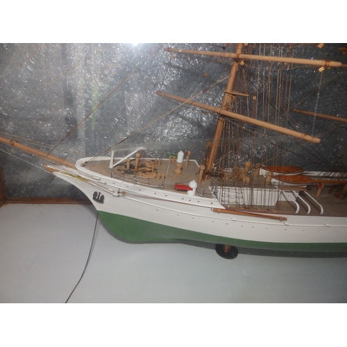 60a - A painted wooden model in glazed display case of the USCGC Barque Eagle, on mahogany stand with roun... 