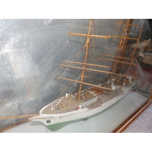 60a - A painted wooden model in glazed display case of the USCGC Barque Eagle, on mahogany stand with roun... 