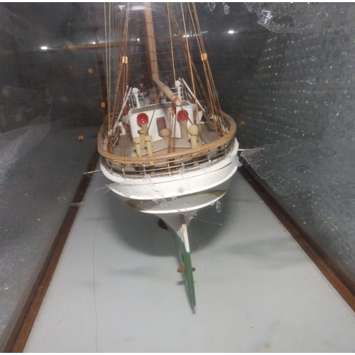 60a - A painted wooden model in glazed display case of the USCGC Barque Eagle, on mahogany stand with roun... 