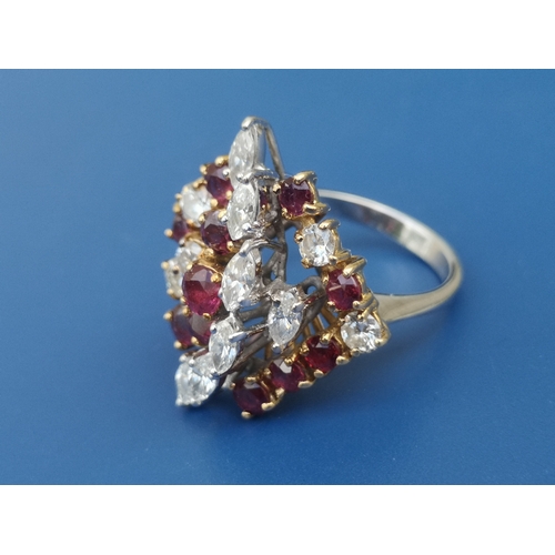 174 - A 1950's/60's ruby & diamond set cocktail ring, of open tiered asymmetric design, claw set with nume... 