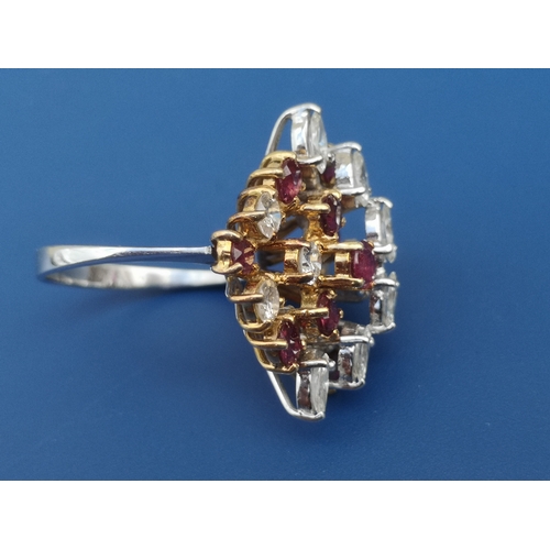 174 - A 1950's/60's ruby & diamond set cocktail ring, of open tiered asymmetric design, claw set with nume... 