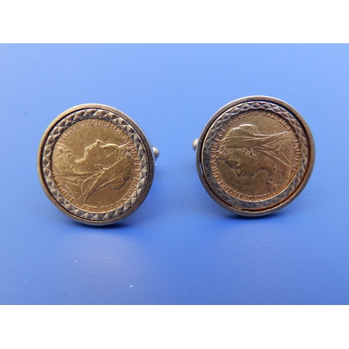 179 - A pair of 9ct gold cufflinks each set with a Victorian half sovereign.