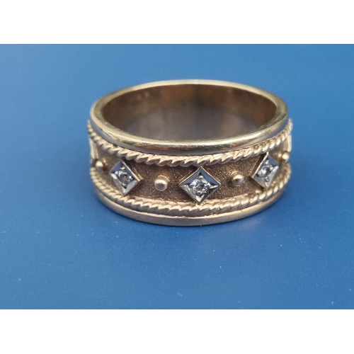 184 - A 9ct gold dress band ring set with five small diamonds.  Finger size P/Q.