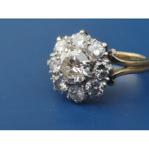 185 - A diamond claw set cluster ring on 18ct shank.  Finger size H.