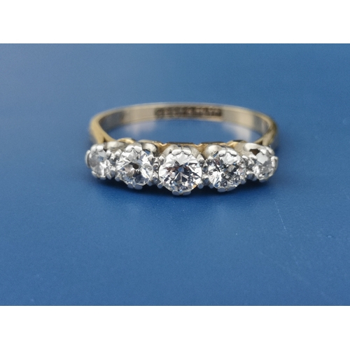 189 - A five stone graduated claw set diamond ring, the central stone weighing approximately 0.20 carat - ... 