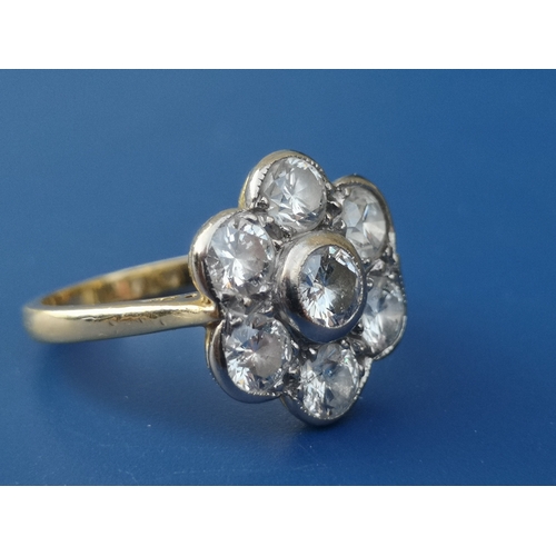 190 - A diamond 'daisy' cluster ring, the seven collet set brilliants of total weight approximately 1.8 ca... 