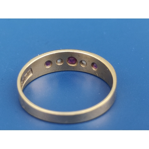 201 - An 18ct gold band ring set with two small rose cut diamonds and three rubies.  Finger size N.