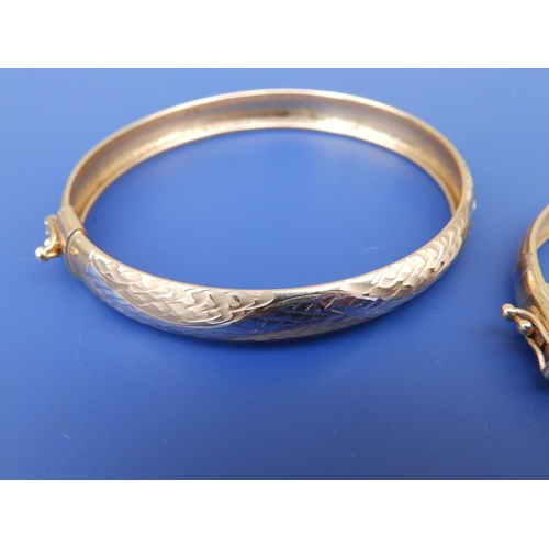 220 - A 585 yellow metal bangle and one other. (2)