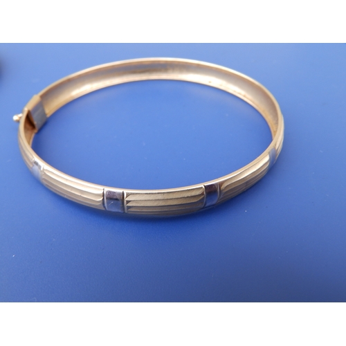 220 - A 585 yellow metal bangle and one other. (2)