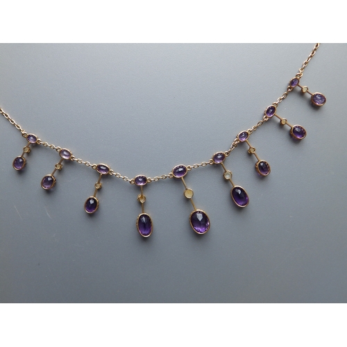 163 - A late Victorian/Edwardian amethyst & pearl set gold fringe necklace, 17.5