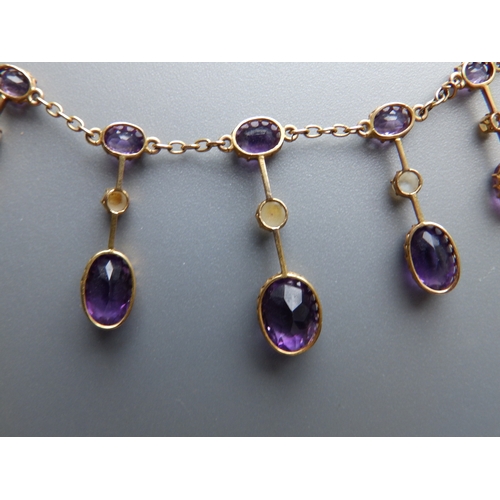 163 - A late Victorian/Edwardian amethyst & pearl set gold fringe necklace, 17.5