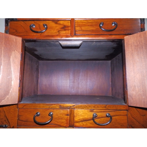 61 - An  Oriental table-top cabinet with iron mounts, 23