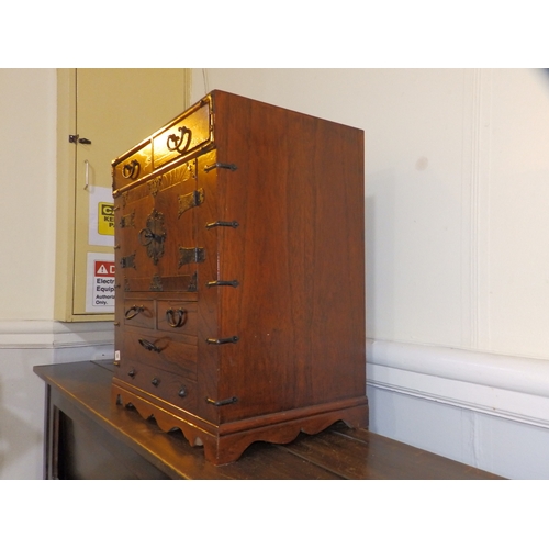 61 - An  Oriental table-top cabinet with iron mounts, 23