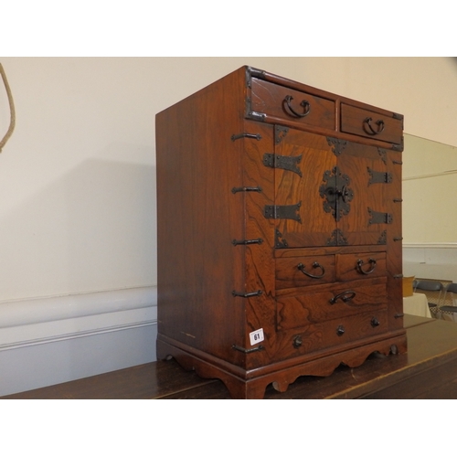 61 - An  Oriental table-top cabinet with iron mounts, 23