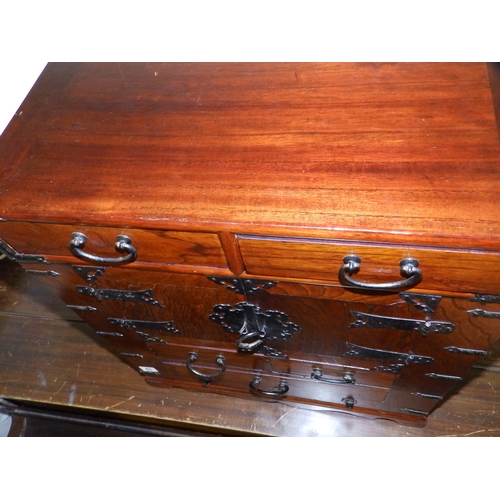 61 - An  Oriental table-top cabinet with iron mounts, 23