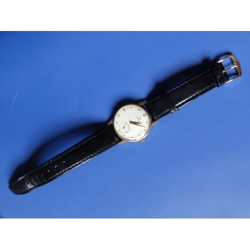 A gent's 14K gold Omega wrist watch, the silvered dial with gold