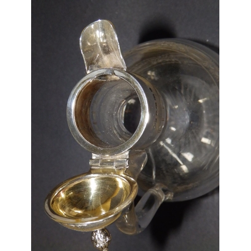 120 - A Victorian silver mounted jug, having hinged cover, glass loop handle onto rounded body with shallo... 