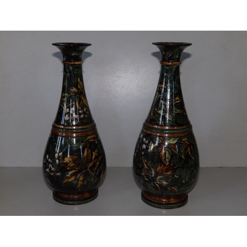 58 - A pair of Doulton Lambeth 'faience' vases by Walter Gandy, decorated overall floqwering foliage on a... 