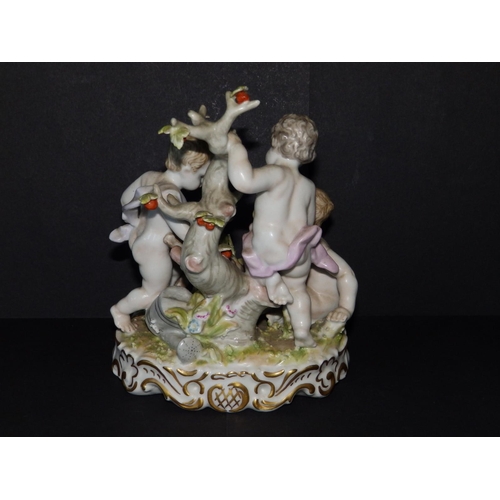 59 - A continental porcelain group depicting three putti gathering fruit & flowers, 7