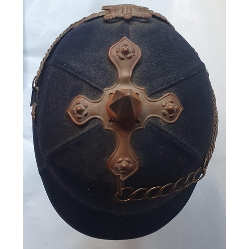 73 - A military helmet with gilt metal mounts.