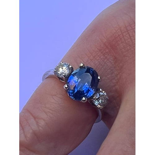 210 - A three stone sapphire & diamond ring, the four-claw set cushion cut sapphire weighing approximately... 