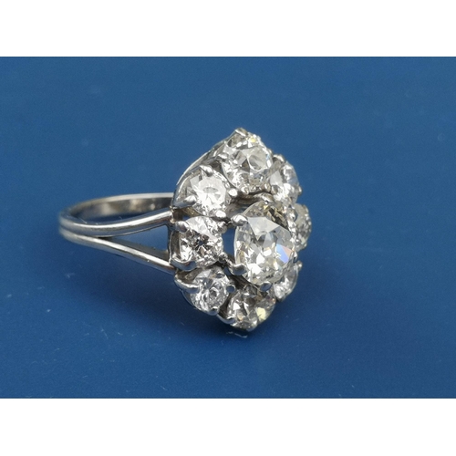 215 - A  large diamond set oval cluster ring, the central old cut stone surrounded by four old cuts and fo... 