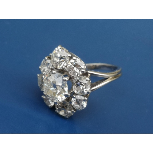 215 - A  large diamond set oval cluster ring, the central old cut stone surrounded by four old cuts and fo... 