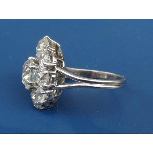 215 - A  large diamond set oval cluster ring, the central old cut stone surrounded by four old cuts and fo... 