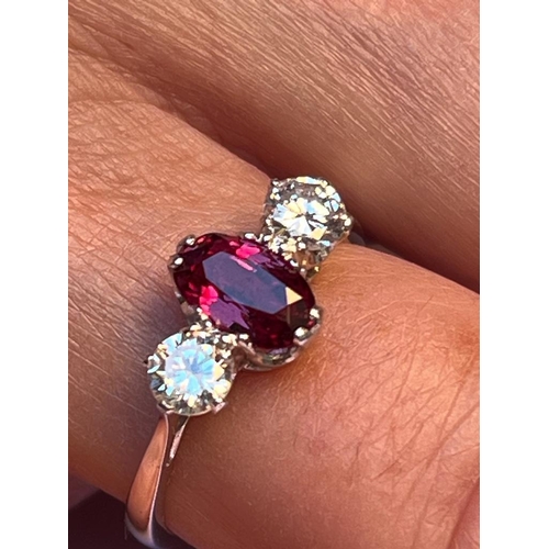 220 - A certified natural ruby & diamond three stone ring, the claw set cushion cut ruby weighing approxim... 