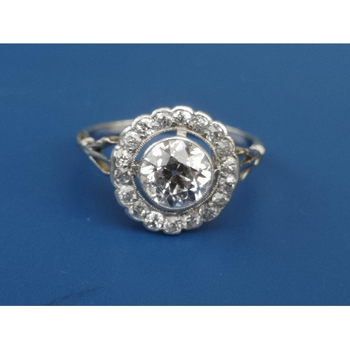 228 - An Edwardian diamond set cluster ring, the central old cut stone weighing in excess of one carat, on... 