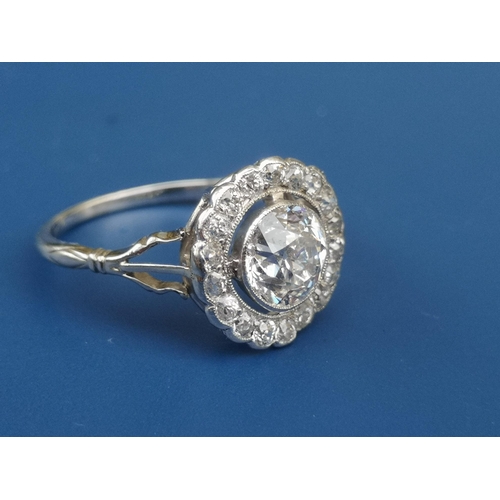 228 - An Edwardian diamond set cluster ring, the central old cut stone weighing in excess of one carat, on... 